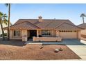 Single-story home with tile roof and desert landscaping at 13917 W Pavillion Dr, Sun City West, AZ 85375