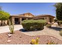 Single-story home with landscaped front yard and two-car garage at 14960 W Cottonwood St, Surprise, AZ 85374