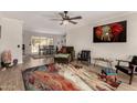 Open living room with wood-look floors and colorful rug at 16033 N 110Th Ave, Sun City, AZ 85351