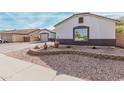 Landscaped front yard with decorative planters and a view of the home's facade and three-car garage at 17347 W Statler St, Surprise, AZ 85388