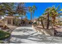 Long driveway leading to a beautiful home with palm trees at 19127 E Wiki Way, Rio Verde, AZ 85263