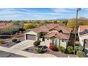 Single-story home with tile roof, landscaped yard, and two-car garage at 20642 N 268Th Dr, Buckeye, AZ 85396