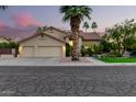 Charming two-story home with a three-car garage, well-manicured lawn, mature landscaping and tile roof at 211 E Dawn Dr, Tempe, AZ 85284