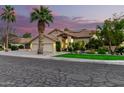 Charming two-story home with a three-car garage, well-manicured lawn, mature landscaping and tile roof at 211 E Dawn Dr, Tempe, AZ 85284