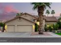 Charming two-story home with a three-car garage, well-manicured lawn, mature landscaping and tile roof at 211 E Dawn Dr, Tempe, AZ 85284