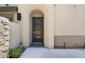 Stylish front door with arched entryway and stone accents at 23393 N 73Rd Way, Scottsdale, AZ 85255