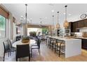 Open concept kitchen with island, modern cabinetry, and pendant lighting at 23393 N 73Rd Way, Scottsdale, AZ 85255