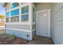 Close-up of a light blue home's front door and corner windows at 235 N 22Nd Pl # 565, Mesa, AZ 85213