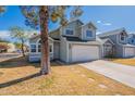 Charming two-story home with an attached garage and mature trees in the front yard at 235 N 22Nd Pl # 565, Mesa, AZ 85213