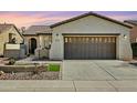 Single-story home with a two-car garage and landscaped front yard at 28107 N 123Rd Ln, Peoria, AZ 85383