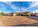 House with gravel driveway and mature shrubs at 3125 W Waltann Ln, Phoenix, AZ 85053