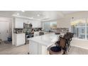 Modern kitchen with white cabinets, quartz countertops, and stainless steel appliances at 3125 W Waltann Ln, Phoenix, AZ 85053