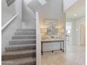 Modern staircase with grey carpet and contemporary console table at 5099 E Umber Rd, San Tan Valley, AZ 85143