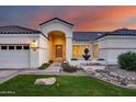 Well maintained home with a three-car garage, fountain, and lush lawn at 5635 W Melinda Ln, Glendale, AZ 85308