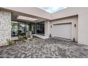 Elegant entry with stonework, water feature, and glass doors at 7153 E Ironwood Dr, Paradise Valley, AZ 85253