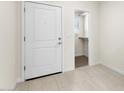 Bright entryway with tile flooring, coat closet, and white door at 7511 S 75Th Dr, Laveen, AZ 85339