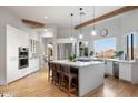 Modern kitchen with white cabinets, a large island, and mountain views at 8150 N 47Th St, Paradise Valley, AZ 85253