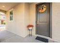 Charming front entry with decorative wreath, potted plants, and a covered porch at 8535 E Olla Ave, Mesa, AZ 85212