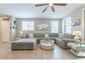 Inviting living room featuring a large sectional sofa, neutral color palette, and plenty of space at 8535 E Olla Ave, Mesa, AZ 85212