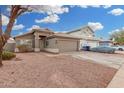 House exterior with a two-car garage and gravel landscaping at 8732 W Granada Rd, Phoenix, AZ 85037