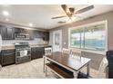 Eat-in kitchen featuring dark cabinets, granite countertops, and a stainless steel gas range and appliances at 10433 E Boise St, Apache Junction, AZ 85120