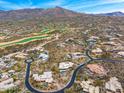 Panoramic aerial view of a desert community surrounded by mountains and golf courses at 10712 E Prospect Point Dr, Scottsdale, AZ 85262