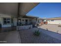 Spacious, covered front porch and gate, with desert landscaping, offering privacy and shade at 10906 W Boswell Blvd, Sun City, AZ 85373