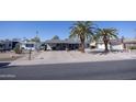 Inviting single-story home with desert landscaping and palm trees, offering a peaceful neighborhood setting at 10906 W Boswell Blvd, Sun City, AZ 85373