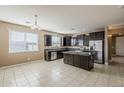 Bright kitchen featuring dark cabinetry, stainless steel appliances, granite counters, and a practical center island at 1203 E Judi St, Casa Grande, AZ 85122