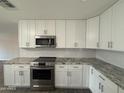 Updated kitchen featuring granite countertops, stainless steel appliances, and bright white cabinetry at 12415 W Rock Springs Dr, Sun City West, AZ 85375