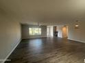 Spacious living room with wood-look tile flooring and ample natural light from a large window at 12415 W Rock Springs Dr, Sun City West, AZ 85375