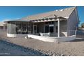 Covered patio with seating area and screened enclosure at 13709 W Gunsight Dr, Sun City West, AZ 85375