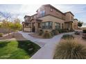 Front view of tan two-story home with walkway at 14870 W Encanto Blvd # 1014, Goodyear, AZ 85395