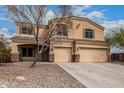 Charming two-story home boasts a spacious driveway, well-kept yard, and a two-car garage at 23000 W Kimberly Dr, Buckeye, AZ 85326