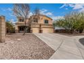 Charming two-story home boasts a spacious driveway, well-kept yard, and a two-car garage at 23000 W Kimberly Dr, Buckeye, AZ 85326