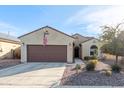 Tan house with brown garage door and desert landscaping at 2303 N General Dr, Florence, AZ 85132