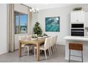 Bright dining room featuring a light wood table and six chairs at 24216 W Agora Ln Ln, Buckeye, AZ 85326