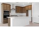 Modern kitchen featuring an island, stainless steel appliances, stylish espresso cabinets, and sleek tile flooring at 24216 W Agora Ln Ln, Buckeye, AZ 85326