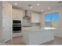 Bright kitchen showcasing white cabinets, stainless steel appliances, and a large island at 24224 W Agora Ln, Buckeye, AZ 85326