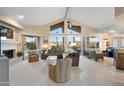 Spacious living room with floor-to-ceiling windows showing mountain views, neutral decor, and fireplace at 25625 N Abajo Dr, Rio Verde, AZ 85263