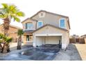 Two-story house with tan exterior, two-car garage, and desert landscaping at 3307 W Leodra Ln, Phoenix, AZ 85041