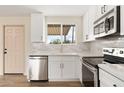 Bright kitchen with white cabinets, stainless steel appliances, and a window view at 5313 W Osborn Rd, Phoenix, AZ 85031