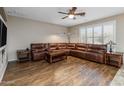 Spacious living room with hardwood floors and a large sectional sofa at 6238 W Buckhorn Trl, Phoenix, AZ 85083