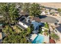 An aerial view of a home showcasing a pool, solar panels, and mature landscaping on an expansive lot at 6811 E Juniper Ave, Scottsdale, AZ 85254