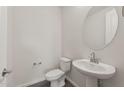 Small powder room with pedestal sink and toilet at 7163 W Oberlin Way, Peoria, AZ 85383