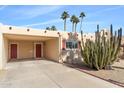 Single level home with covered carport and red door at 7714 E Mariposa Dr, Scottsdale, AZ 85251