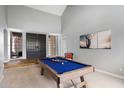 Bright game room with vaulted ceiling, a billiard table, and stylish desert-themed artwork at 9504 E Sunnyside Dr, Scottsdale, AZ 85260