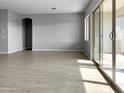 Bright living room with tile floors and sliding glass doors at 15787 W Mariposa Grande --, Surprise, AZ 85387