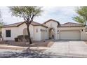 Well maintained single-story home featuring a terracotta roof, three car garage, stucco exterior, and drought-resistant landscaping at 1723 W Brianna Rd, Phoenix, AZ 85085