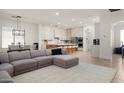 Open floorplan view of a comfortable living room and dining area leading into a modern, renovated kitchen at 1723 W Brianna Rd, Phoenix, AZ 85085